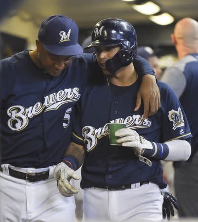 Sep 4, 2018; Milwaukee, WI, USA; Milwaukee Brewers shortstop Orlando Arcia (3) gets a hug from second baseman Jonathan Schoop (5) after scoring a run in the sixth inning during the game against the Chicago Cubs at Miller Park. Mandatory Credit: Benny Sieu-USA TODAY Sports