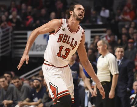 Chicago's Joakim Noah (13) reacts after dislocating his shoulder against the Dallas Mavericks. (USA Today)