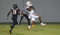 Miami wide receiver Dee Wiggins (8) pulls in a 39-yard touchdown reception as North Carolina State defensive back Joshua Pierre-Louis (19) trails during the first half of an NCAA college football game Friday, Nov. 6, 2020, in Raleigh, N.C. (Ethan Hyman/The News & Observer via AP, Pool)