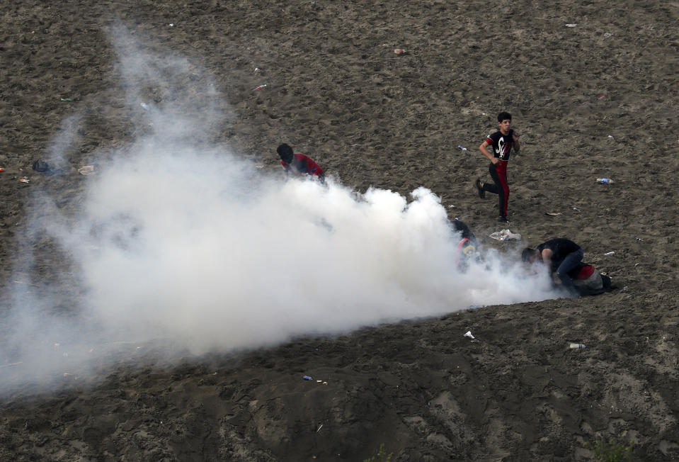 Iraqi security forces use tear gas to disperse anti-government protesters in Baghdad, Iraq, Wednesday, Oct. 30, 2019. (AP Photo/Hadi Mizban)