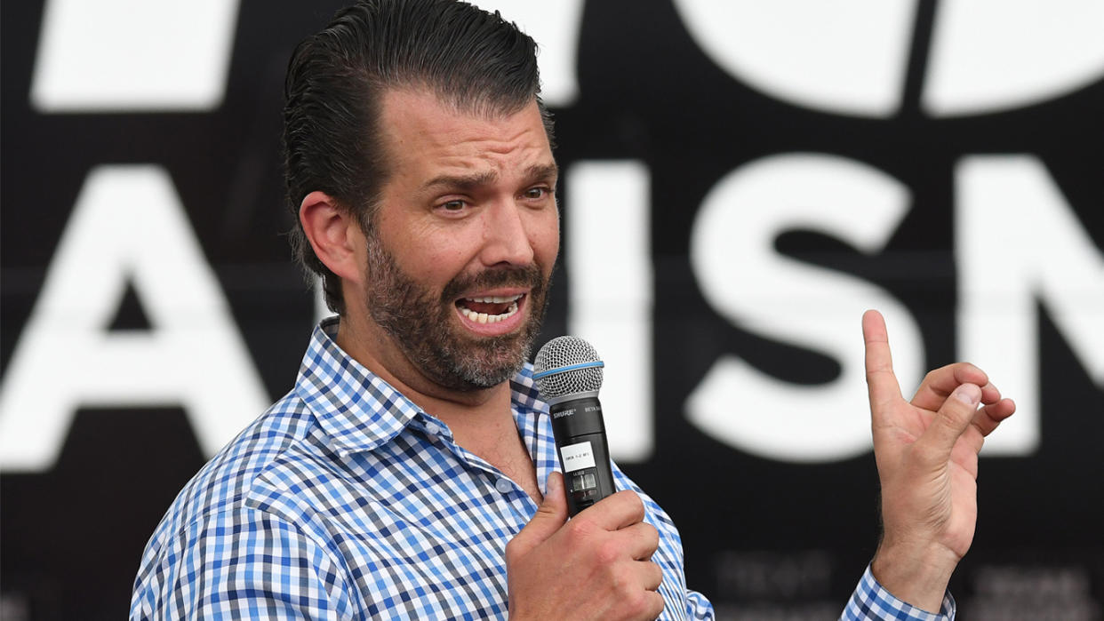 Donald Trump Jr speaks during a rain shower to an audience wearing ponchos at a Fighters Against Socialism campaign rally in support of his father, U.S. President Donald Trump. (Paul Hennessy/SOPA Images/LightRocket via Getty Images)