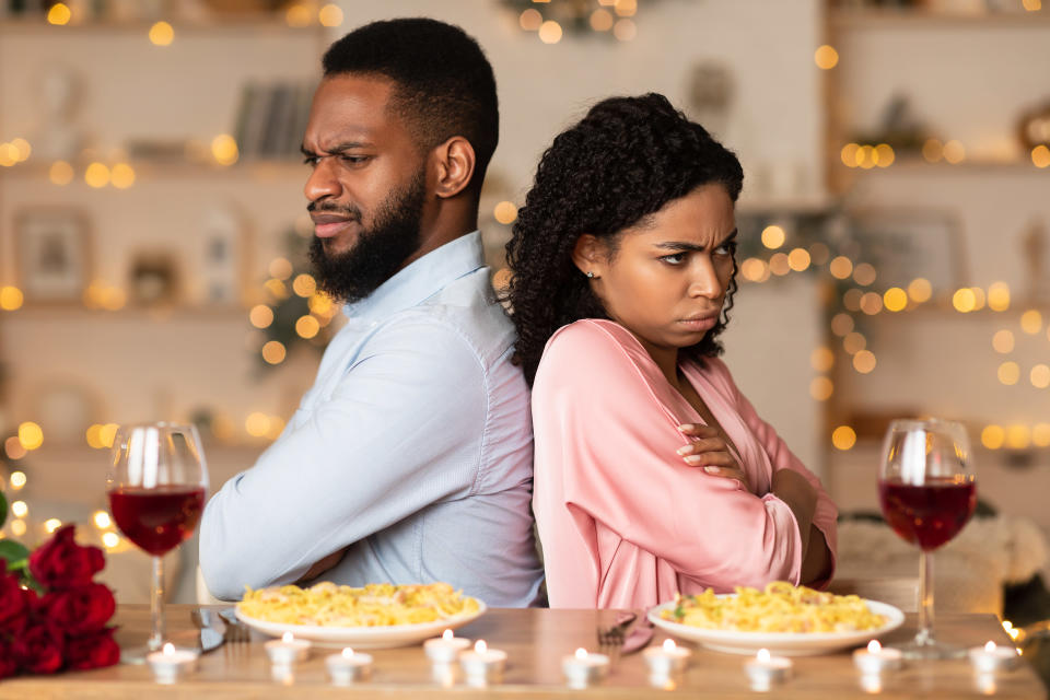 An unhappy man and woman during a holiday family dinner. (Photo via Getty Images)