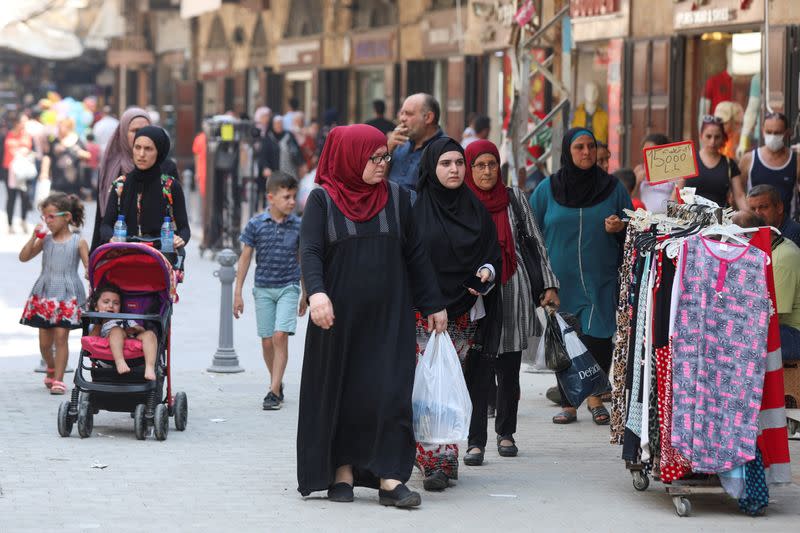 People walk at a souk ahead of the Eid al-Adha celebrations in Tripoli