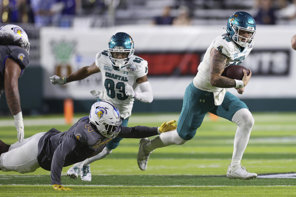 San Jose State linebacker Jordan Cobbs (44) can't grab Coastal Carolina quarterback Ethan Vasko (16) during the first half of the Hawaii Bowl NCAA college football game Saturday, Dec. 23, 2023, in Honolulu. (AP Photo/Marco Garcia)