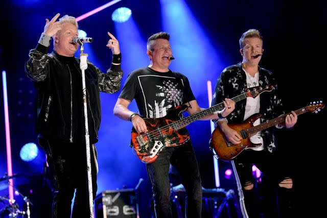 <p>Jason Kempin/Getty</p> Gary LeVox, Jay DeMarcus and Joe Don Rooney of Rascal Flatts in 2019.