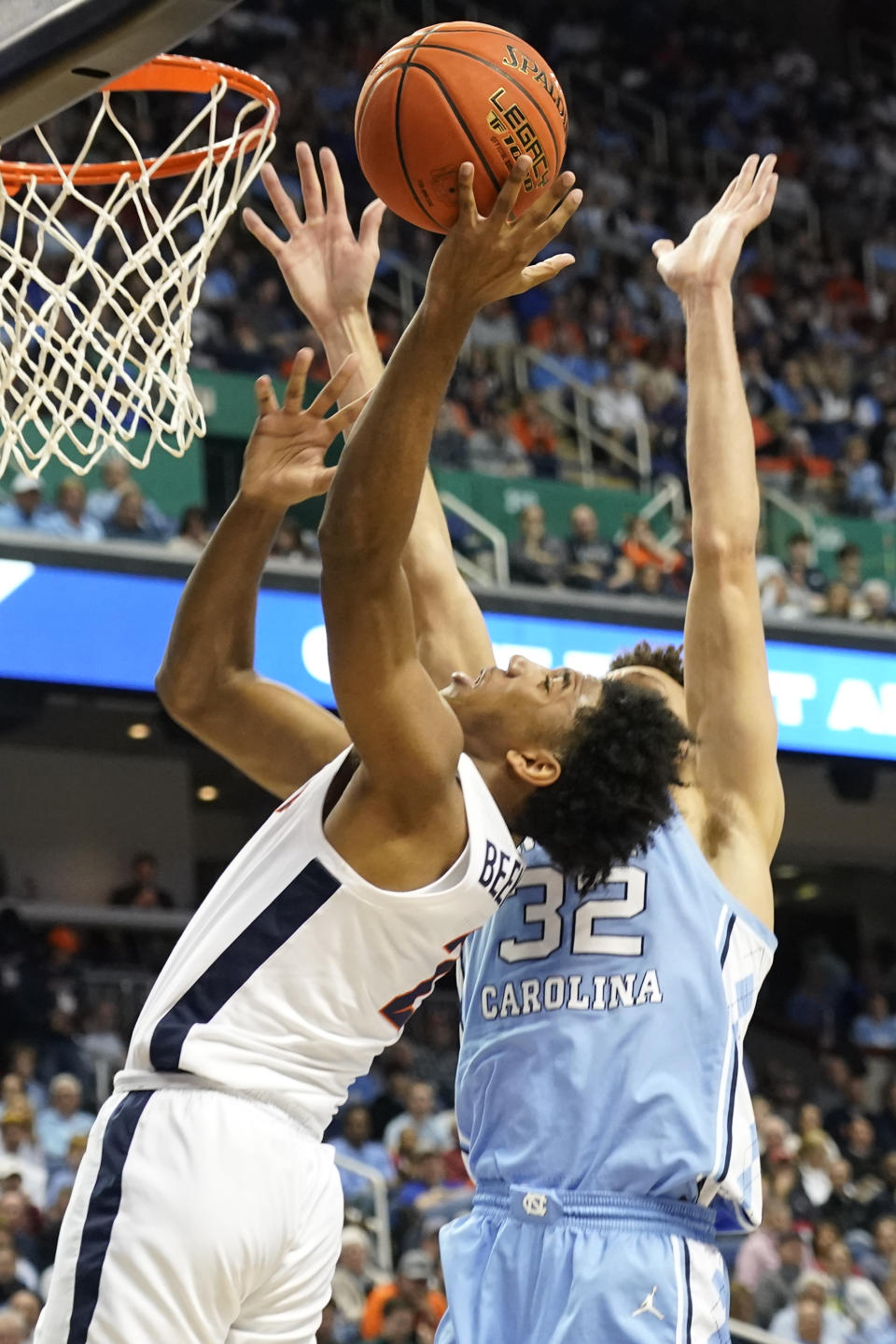 Virginia guard Reece Beekman (2) shoots against North Carolina forward Pete Nance (32) during the first half of an NCAA college basketball game at the Atlantic Coast Conference Tournament in Greensboro, N.C., Thursday, March 9, 2023. (AP Photo/Chuck Burton)