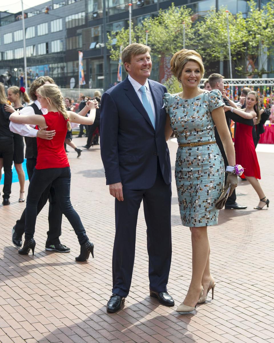 Netherlands' King Willem Alexander, left and Queen Maxima, right, watching a group of Tango dancers during festivities marking King's Day in Amstelveen, near Amsterdam, Netherlands, Saturday, April 26, 2014. The Dutch celebrate the first ever King's Day, a national holiday held in honor of the newly installed monarch, King Willem Alexander. King's Day replaces the traditional Queen's Day. (AP Photo/Patrick Post)