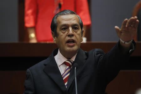 Rogelio Ortega, former secretary-general of the Autonomous University of Guerrero, gestures as he becomes the acting governor of Guerrero at the City Congress in Chilpancingo, in the southern Mexican state of Guerrero, October 26, 2014. REUTERS/Jorge Dan Lopez