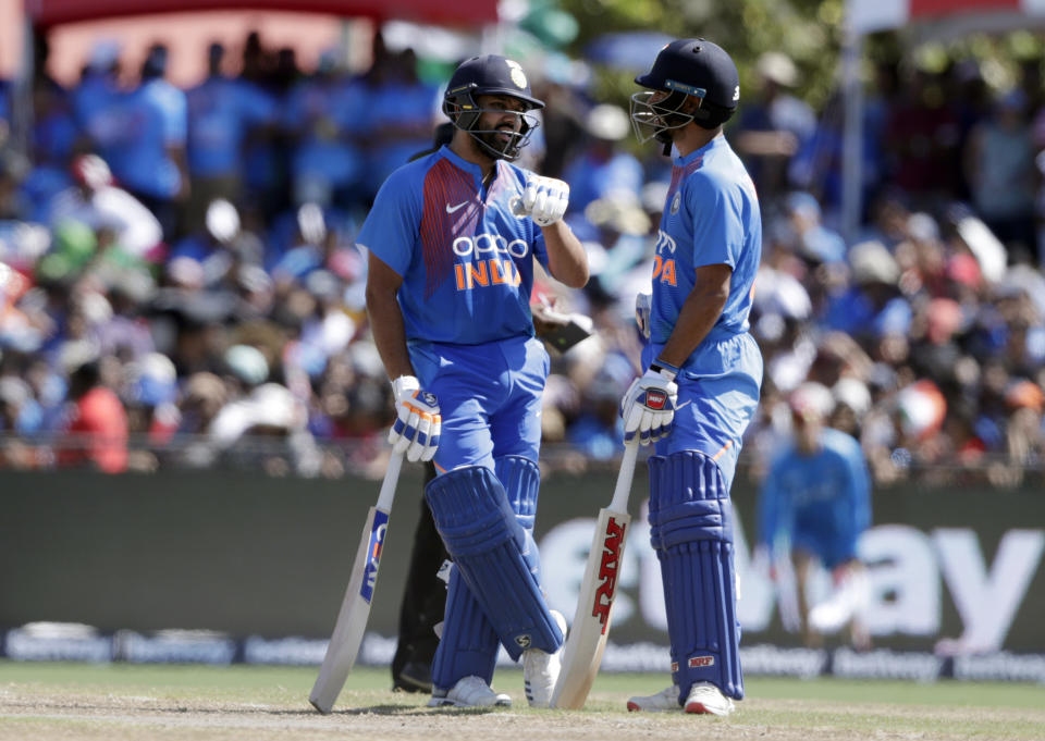India's Rohit Sharma, left, and Shikhar Dhawan, right, talk during the second Twenty20 international cricket match against the West Indies, Sunday, Aug. 4, 2019, in Lauderhill, Fla. (AP Photo/Lynne Sladky)
