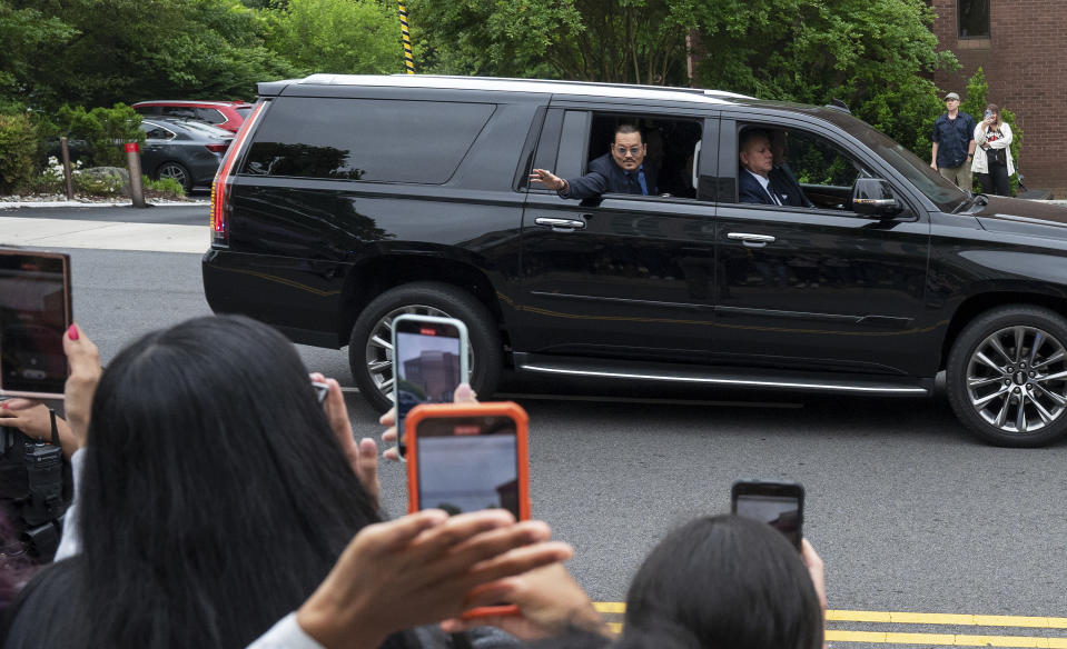 Actor Johnny Depp waves to supporters as he arrives at Fairfax County Courthouse as a jury is scheduled to hear closing arguments in Depp's high-profile libel lawsuit against ex-wife Amber Heard in Fairfax, Va., on Friday, May 27, 2022.(AP Photo/Craig Hudson)