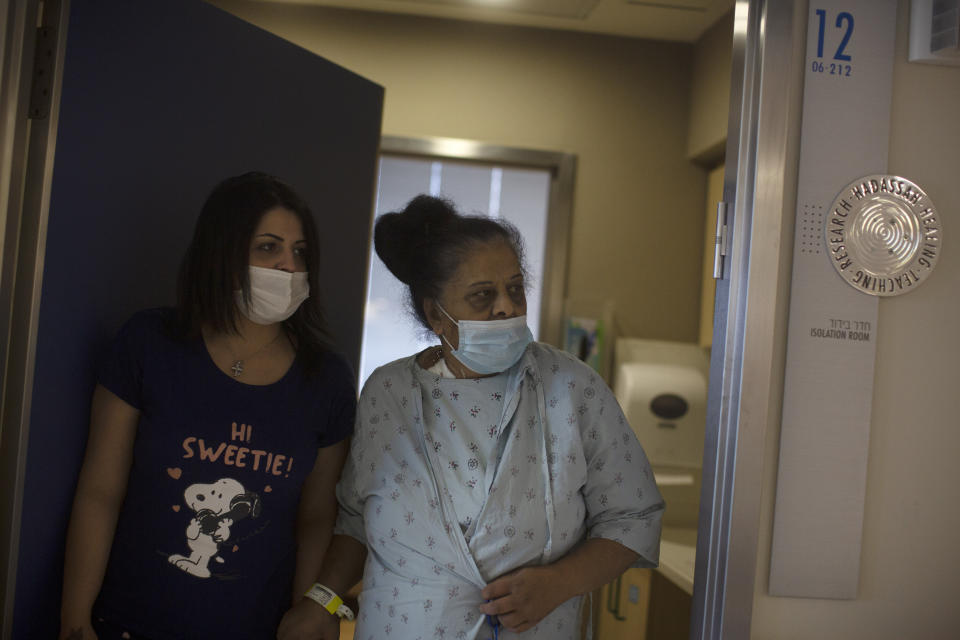 Randa Aweis, right, who received a kidney transplant from Yigal Yehoshua, a Jewish man who died May 17 after being pelted with rocks amid clashes between Arabs and Jews in Israel’s mixed city of Lod, walks with her daughter, Nevine at Hadassah Ein Karem Hospital in Jerusalem, Monday, May 24, 2021. (AP Photo/Maya Alleruzzo)