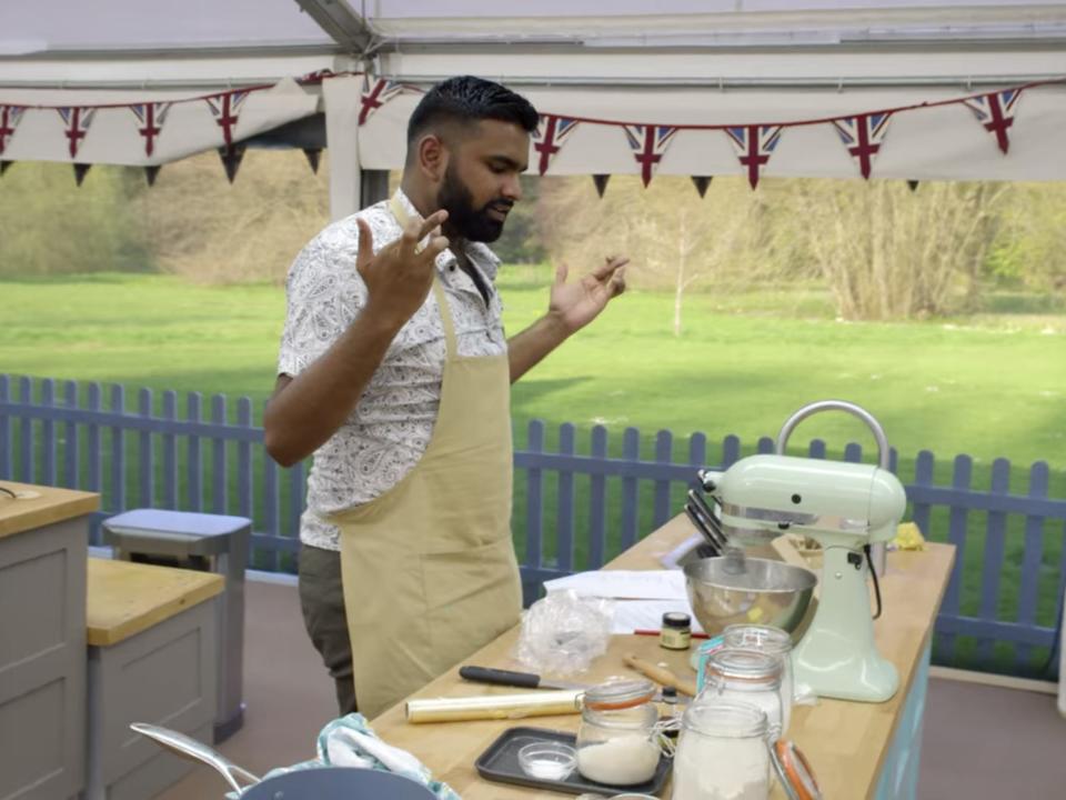 antony crossing his fingers in front of a mixer on great british bake off season 9