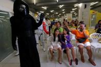 Members of a Star Wars fan club in Thailand, dressed as Kylo Ren, entertains children during Star Wars Day celebration at the Queen Sirikit National Institute of Child Health in Bangkok, Thailand, May 4, 2016. REUTERS/Chaiwat Subprasom