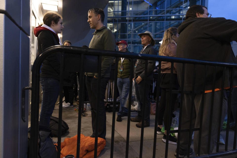 Daphne Kalir-Starr, 13, of New York City waits at the front of the line with her father, Erez Kalir, for the Berkshire Hathaway annual meeting on Saturday, May 6, 2023, in Omaha, Neb. The pair arrived at midnight to secure a spot at the front of the line. (AP Photo/Rebecca S. Gratz)