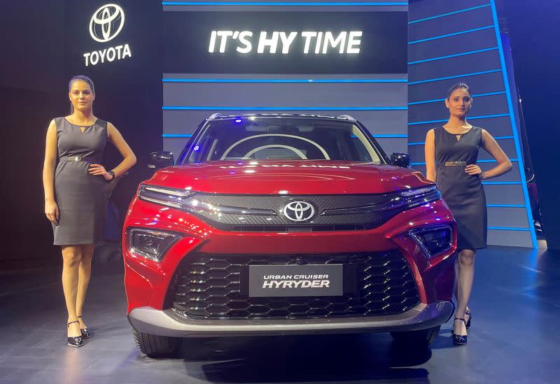 FILE PHOTO: Models pose at the unveiling of Toyota's new hybrid SUV Urban Cruiser Hyryder in New Delhi