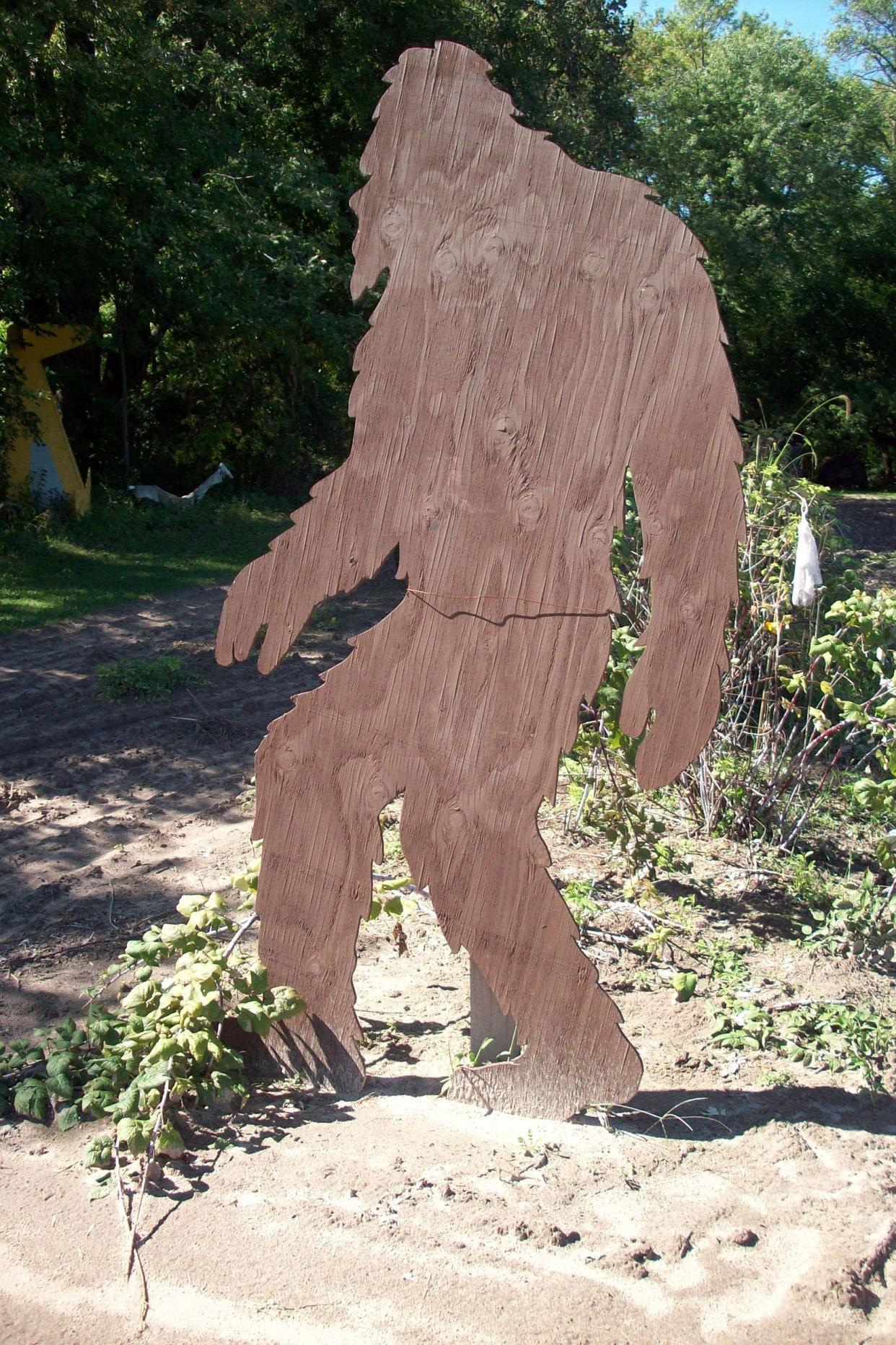 wooden bigfoot in woods