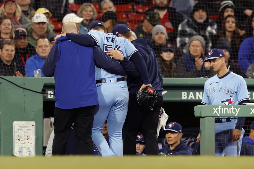 Toronto Blue Jays' Zach Pop (56) is helped off the field during the eighth inning of a baseball game against the Boston Red Sox, Thursday, May 4, 2023, in Boston. (AP Photo/Michael Dwyer)