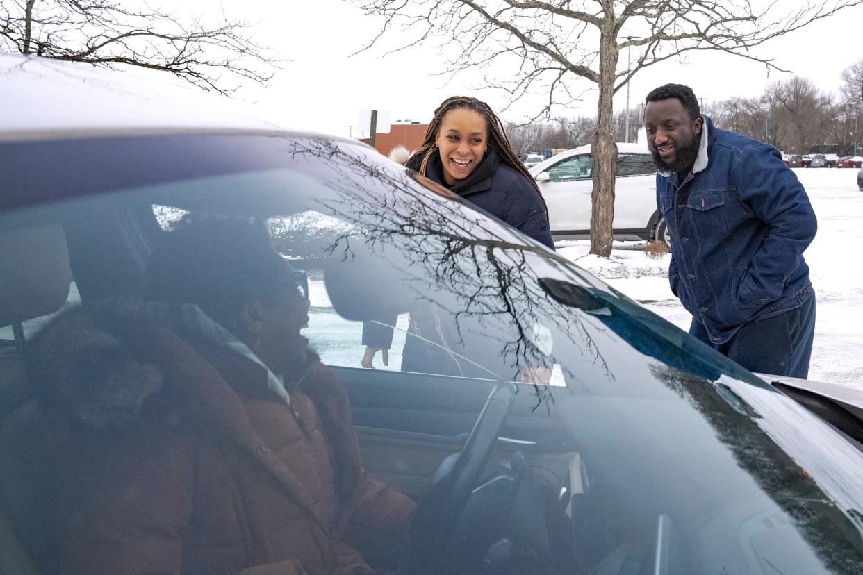 Sheri Neale, of the Near East Side, sits in her car while speaking with Brandis Mason, center, and Will Damson after donating goods Saturday during a gift drive to benefit Kyair and Kason. The twins were recently found after being abducted.