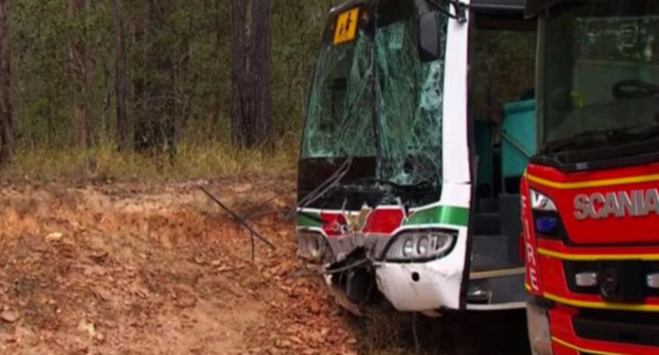 A school bus with a shattered window from a collision with a 4WD.