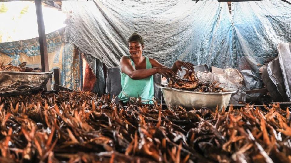 Woman smoking fish, 8 September