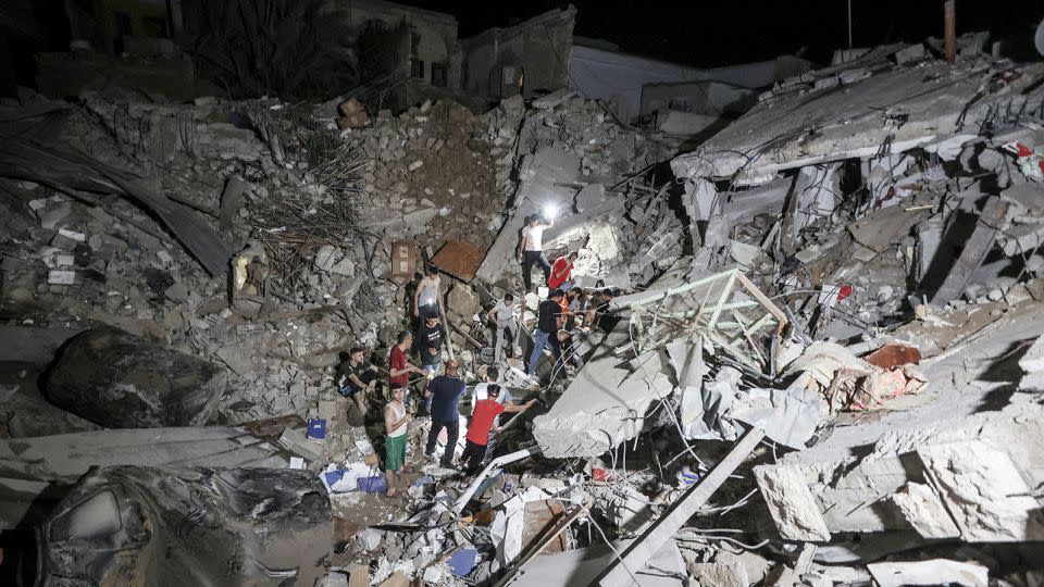 People inspect an area around the Greek Orthodox Church after an Israeli strike in Gaza City, on October 20.  - Ali Jadallah/Anadolu/Getty Images