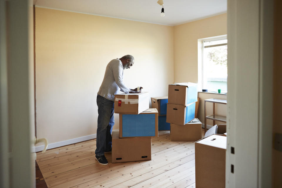 Man packing up moving boxes