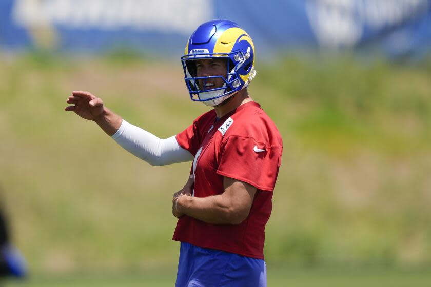 Rams quarterback Matthew Stafford gestures during an organized team activity.