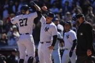 New York Yankees' Giancarlo Stanton (27) celebrates with Anthony Rizzo after they scored on a grand slam by Stanton during the third inning of a baseball game against the Toronto Blue Jays Sunday, April 7, 2024, in New York. (AP Photo/Frank Franklin II)