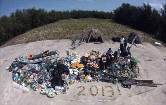 James Morioka, Kerrie Krosky, Kristen Kelly, Tomoko Acoba, Kevin O’Brien, Kerry Reardon, Edmund Coccagna, Joao Garriques, and Russell Reardon (clockwise from upper right) pose on April 18 atop the large, 13,795-kilogram (about 30,400 lbs) pile