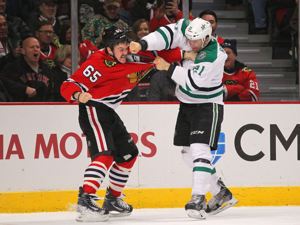 Nov 16, 2014; Chicago, IL, USA; Chicago Blackhawks center Andrew Shaw (65) and Dallas Stars left wing Antoine Roussel (21) fight during the first period at the United Center. (Dennis Wierzbicki-USA TODAY Sports)