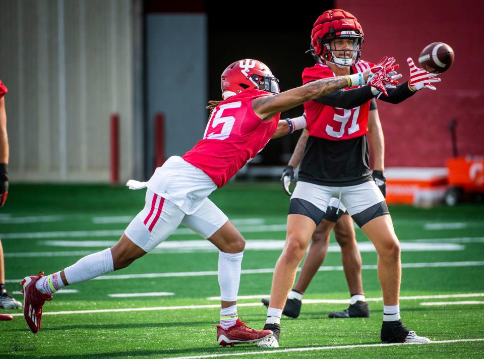 Indiana's Nic Toomer (15) defends a pass intended for Anthony Chung (31) during Indiana football fall camp at the practice fields on Friday, Aug. 11, 2023.