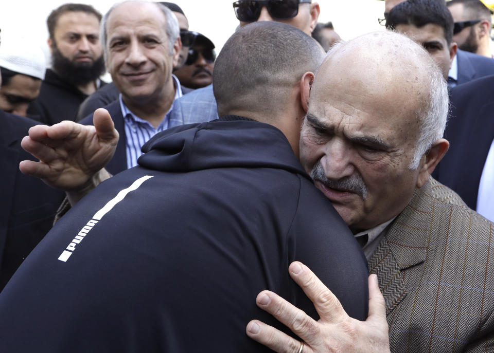 His Royal Highness Prince El Hassan bin Talal Hashemite, right, of the Kingdom of Jordan embraces a worshipper outside the Al Noor mosque in Christchurch, New Zealand, Saturday, March 23, 2019. The mosque reopened today following the March 15 mass shooting. (AP Photo/Mark Baker)