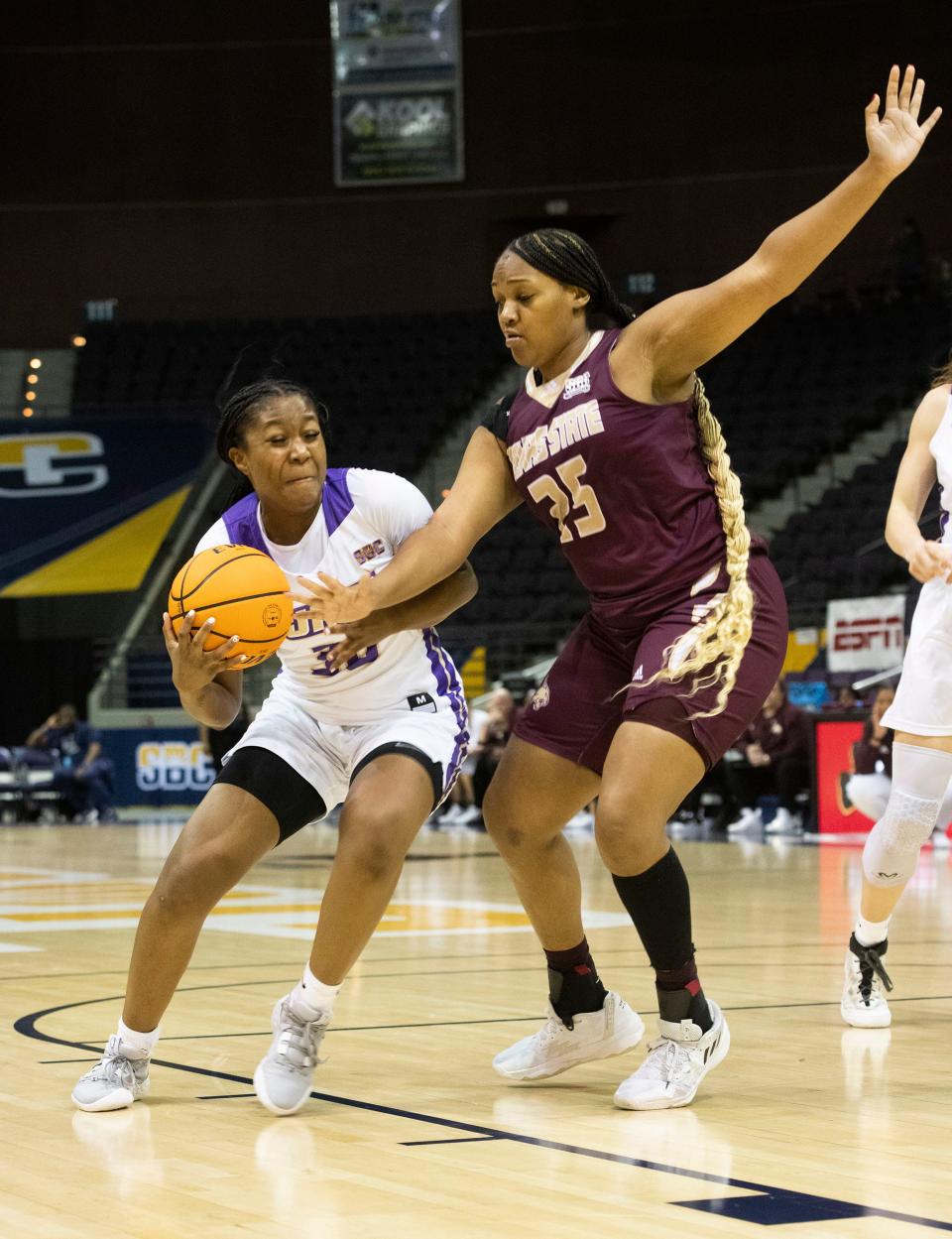 James Madison's  KiKi Jefferson (No. 30) goes in for the layup over the Texas State defense during the SBC Women's Basketball Championship game at the Pensacola Bay Center on Monday, March 6, 2023.