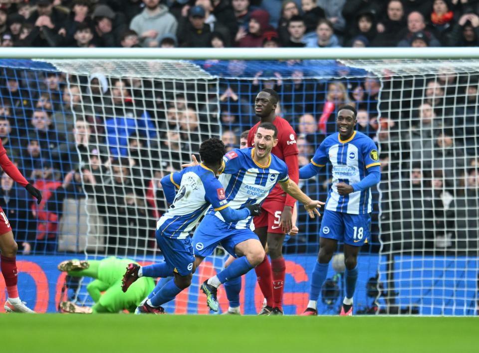 Lewis Dunk celebrates after scoring Brighton’s equaliser (Liverpool FC via Getty Images)
