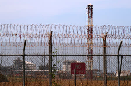 A security fence surrounds the ExxonMobil PNG Limited operated Liquefied Natural Gas (LNG) plant at Caution Bay, located on the outskirts of Port Moresby in Papua New Guinea, November 19, 2018. Picture taken November 19, 2018. REUTERS/David Gray