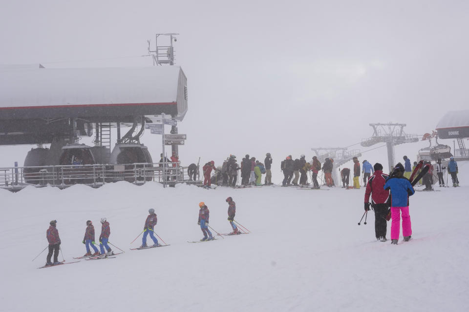 Tourists enjoy skiing, at Plan de Corones ski area, Italy South Tyrol, Saturday, Nov. 27, 2021. After nearly two years of being restricted to watching snow accumulate on distant mountains, Italian skiers are finally returning to the slopes that have been off limits since the first pandemic lockdown in March 2020. But just as the industry is poised to recover from a lost 2020-2021 season after an abrupt closure the previous year, a spike in cases in the Alpine province bordering Austria is underlining just how precarious the situation remains. (AP Photo/Luca Bruno)