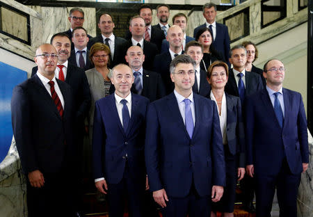 Croatia's new Prime Minister Andrej Plenkovic (C) poses with his ministers after his government was approved by the parliament in Zagreb October 19, 2016. REUTERS/Antonio Bronic