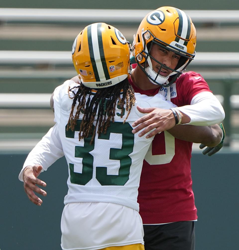 Green Bay Packers teammates Jordan Love and Aaron Jones hug during OTAs in late May.