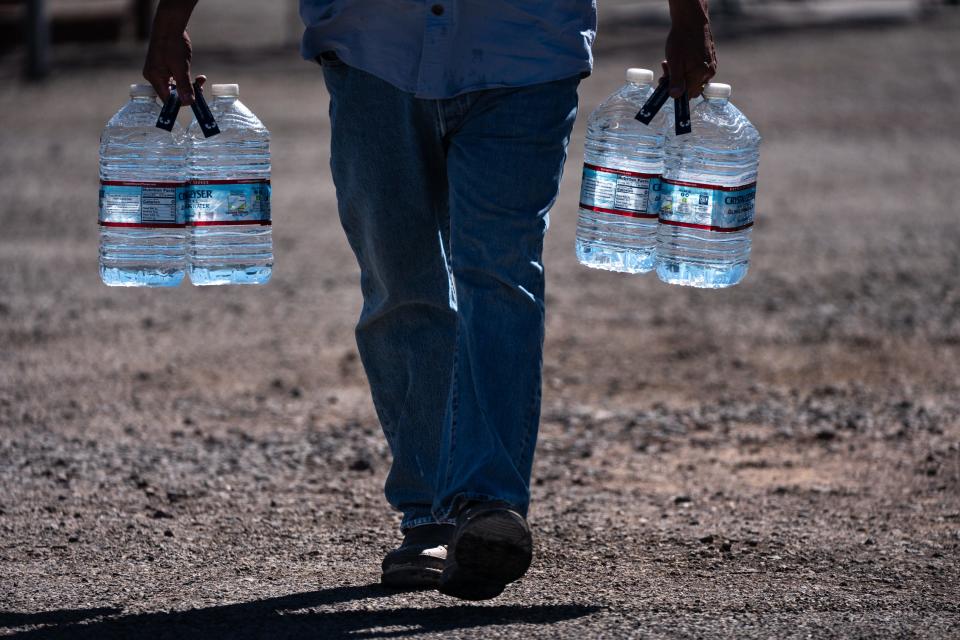 Kim Canady walks back to his RV after filling his water bottles, March 1, 2022, at the Bouse RV Park, 44255 Winters Street, Bouse, Arizona.