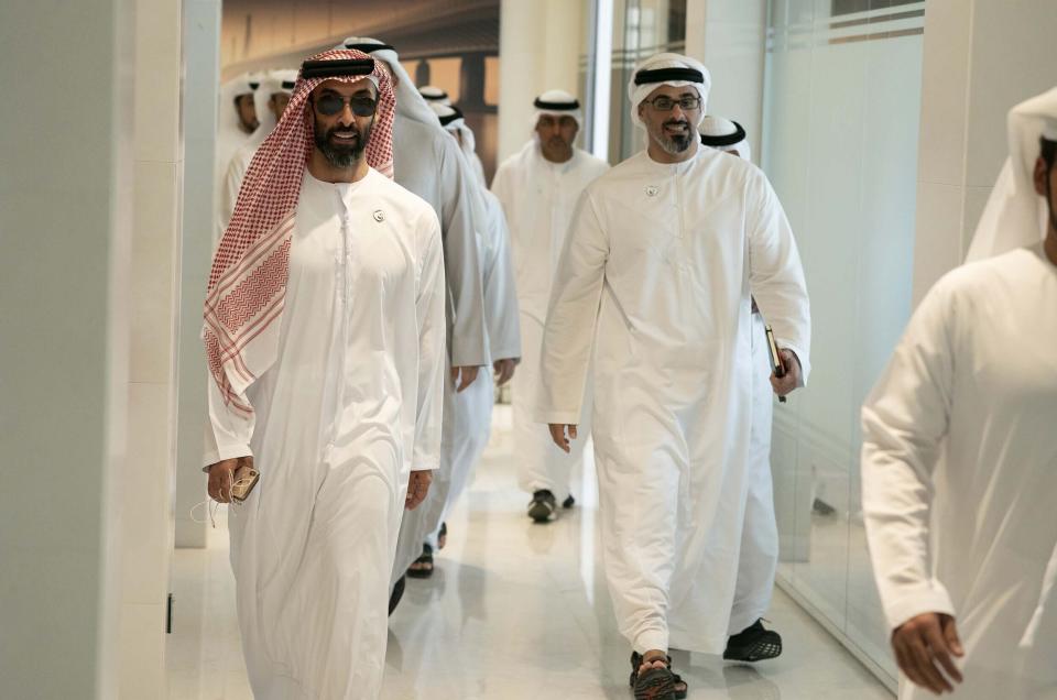 In this Feb. 6, 2019 photo, released by Emirates News Agency, WAM, Sheikh Tahnoun bin Zayed Al Nahyan, left, walks to a meeting in Abu Dhabi, United Arab Emirates. Corporate records and a computer researcher say individuals linked to Sheikh Tahnoun are tied to the video and voice calling app ToTok, which is suspected of being a spying tool of the United Arab Emirates. The app's co-founder, Giacomo Ziani, defended his work in an interview with The Associated Press, while denying knowing that people and companies linked to the project had ties to the country's intelligence apparatus. (WAM via AP)