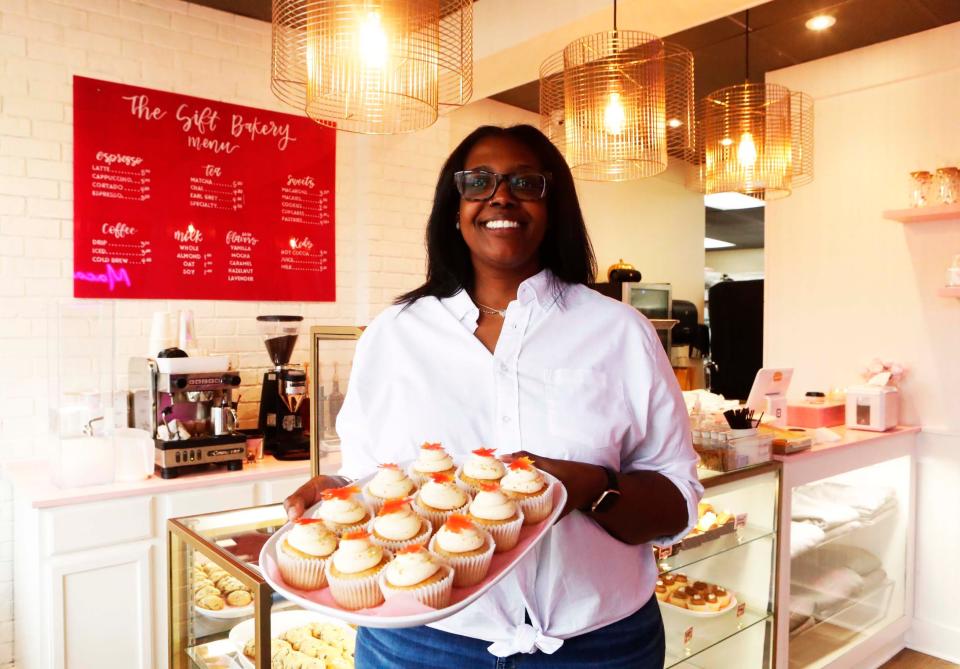 Owner Lonisa “Lala” Bowen holds a tray of cupcakes as she opens up her new The Sift Bakery location on Friday, Nov. 17, 2023, at 5788 Stage Road, Suite 1, in Bartlett, Tenn.