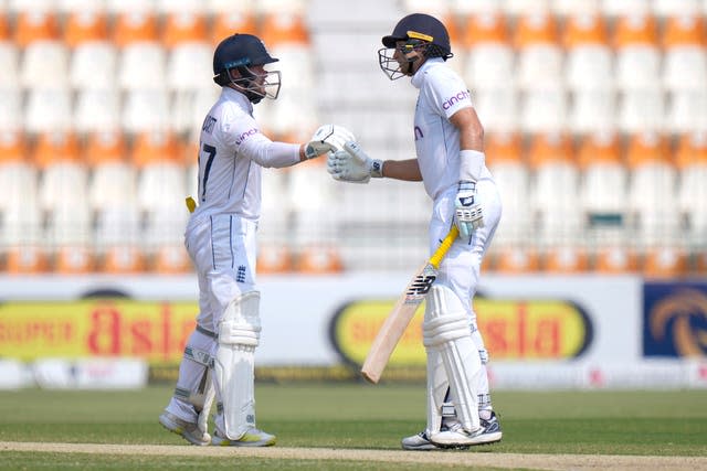 England’s Ben Duckett, left, and Joe Root bump their fists to celebrate 