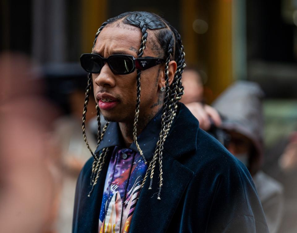 Tyga looks serious while wearing sunglasses