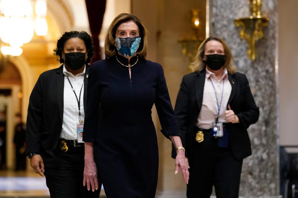 Speaker of the House Nancy Pelosi of California walks through Statuary Hall on Capitol Hill in Washington, Wednesday, Jan. 13, 2021.