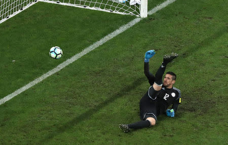 Football Soccer - Brazil v Paraguay - World Cup 2018 Qualifiers - Arena Corinthians stadium, Sao Paulo, Brazil - 28/3/17 - Paraguay's goalkeeper Antony Silva tries to save a goal scored by Brazil's Neymar (not pictured). REUTERS/Paulo Whitaker