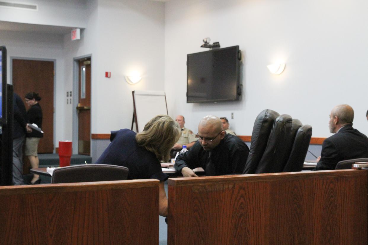 Matias Loza, one of two men accused of being involved in the murder of Richard Valdez in 2011, confers with his legal counsel.