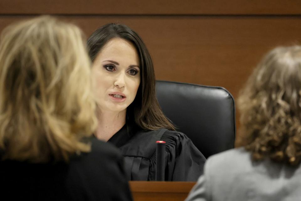 Judge Elizabeth Scherer speaks with Assistant State Attorney Carolyn McCann, left, and Assistant Public Defender Tamara Curtis during a sidebar discussion prior to jury pre-selection in the penalty phase of the trial of Nikolas Cruz at the Broward County Courthouse in Fort Lauderdale, Fla. on Monday, April 25, 2022. The judge presiding over Florida school shooter Nikolas Cruz's death penalty trial was assigned the case despite never having overseen a major trial. (Amy Beth Bennett/South Florida Sun Sentinel via AP, Pool)