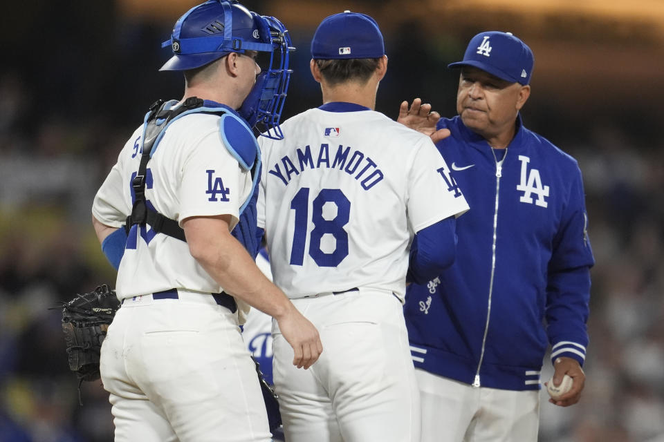 Los Angeles Dodgers starting pitcher Yoshinobu Yamamoto (18) is replaced by manager Dave Roberts, right, during the seventh inning of a baseball game against the Arizona Diamondbacks, Monday, May 20, 2024, in Los Angeles. (AP Photo/Marcio Jose Sanchez)