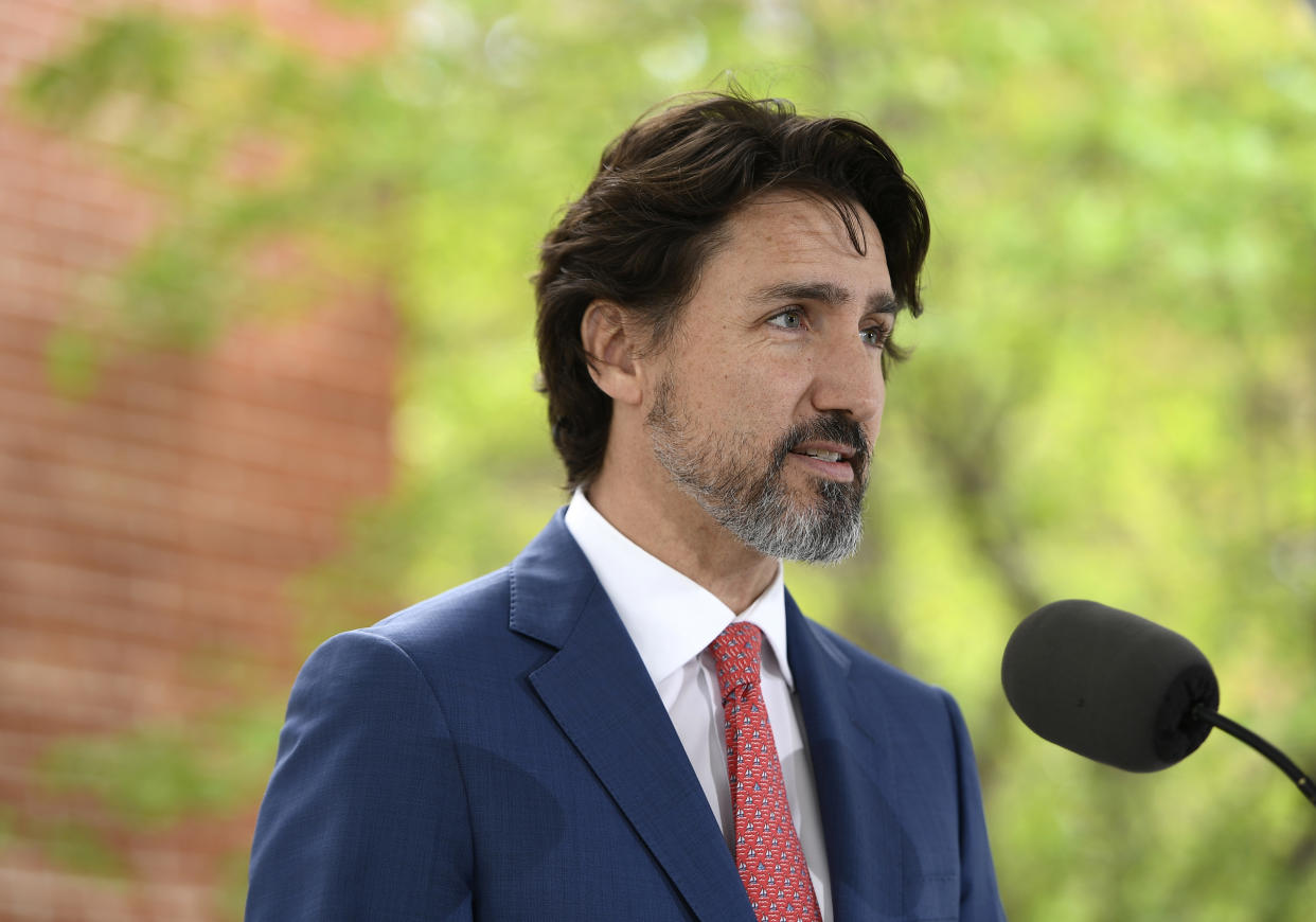 FILE - In this May 19, 2020, file photo, Canadian Prime Minister Justin Trudeau speaks during his daily news conference on the COVID-19 pandemic outside his residence at Rideau Cottage in Ottawa, Ontario. Trudeau said Tuesday, June 2, that Canadians are watching what’s unfolding in the United States with “horror and consternation” and he paused for 21 seconds when asked about U.S. (Justin Tang/The Canadian Press via AP, File)