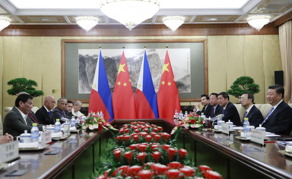 Philippine President Rodrigo Duterte, left, and Chinese President Xi Jinping, right, meet at the Diaoyutai State Guesthouse in Beijing, Thursday, Aug. 29, 2019. (How Hwee Young/Pool Photo via AP)